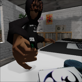 A polygonal person in a room near a computer