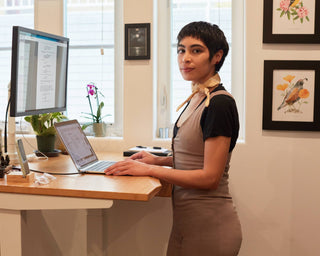 a woman standing in front of standing desk
